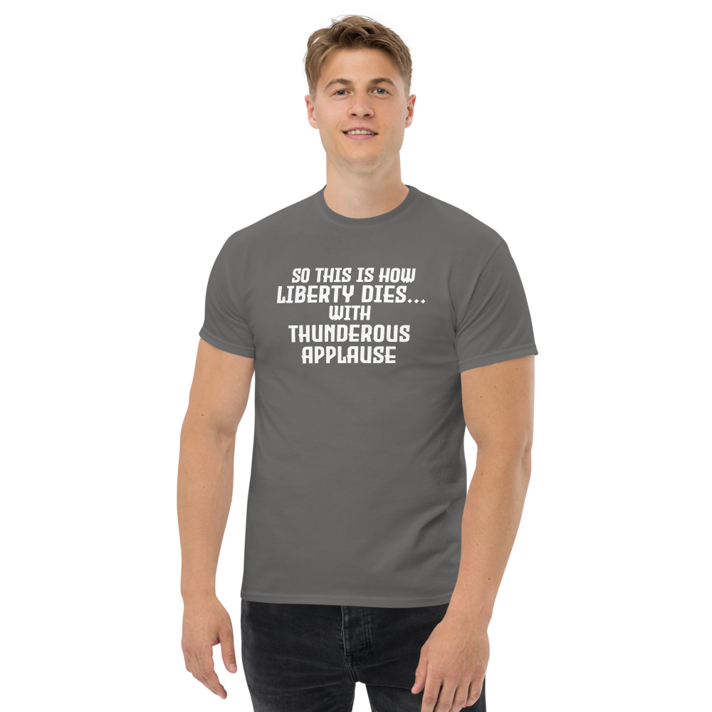 "So this is how liberty dies… with thunderous applause" printed on a charcoal unisex classic tee worn by a male