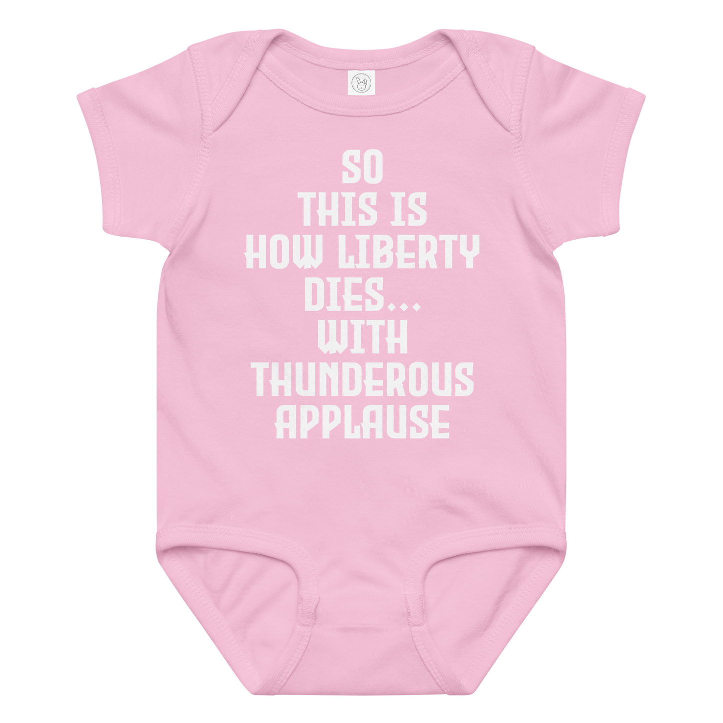 "So this is how liberty dies… with thunderous applause" printed on a pink baby jersey bodysuit laying on a flat surface amongst other clothes