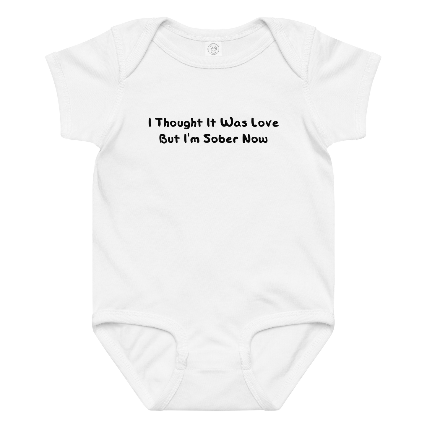 "I thought it was love but I’m sober now" printed on a white baby jersey bodysuit laying on a flat surface amongst other clothes