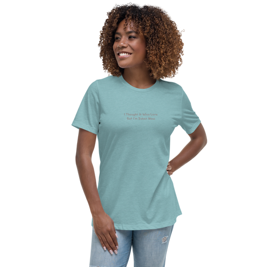 "I thought it was love but I’m sober now" printed on a heather blue lagoon women's relaxed t-shirt worn by a female