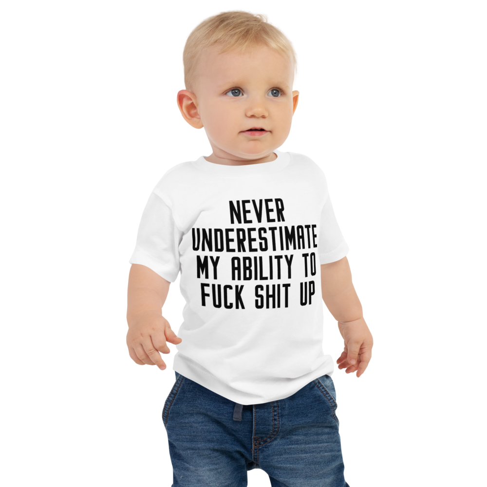 "Never Understimate My Ability To Fuck Shit Up" printed on a white baby jersey short sleeve tee worn by a male