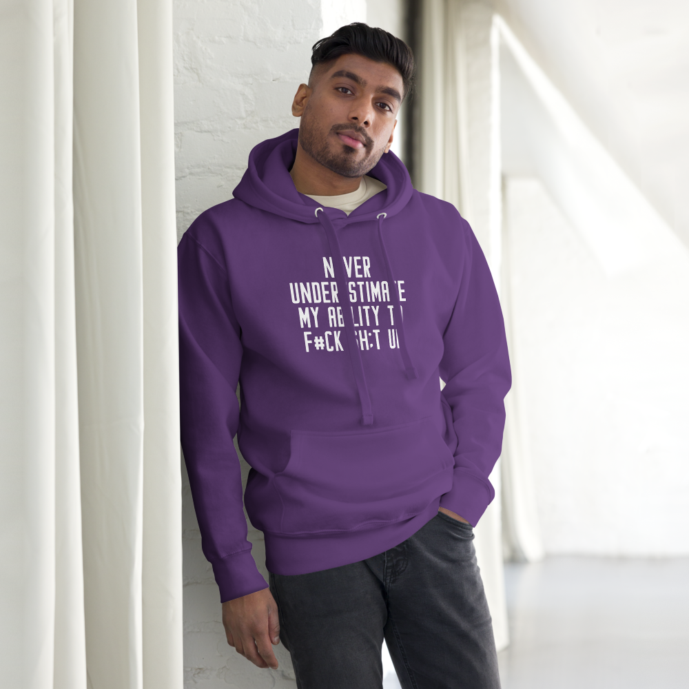 "Never Understimate My Ability To F#Ck Sh:t Up" printed on a purple unisex hoodie worn by a male