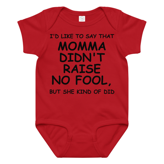 "I'd like to say that momma didn't raise no fool, but she kind of did" printed on a red baby jersey bodysuit laying on a flat surface amongst other clothes