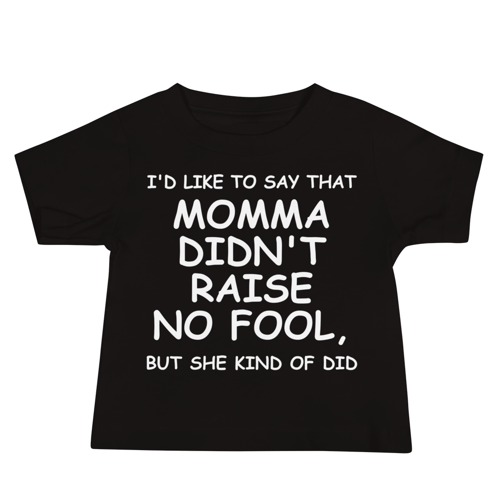 "I'd like to say that momma didn't raise no fool, but she kind of did" printed on a black baby jersey short sleeve tee laying on a flat surface