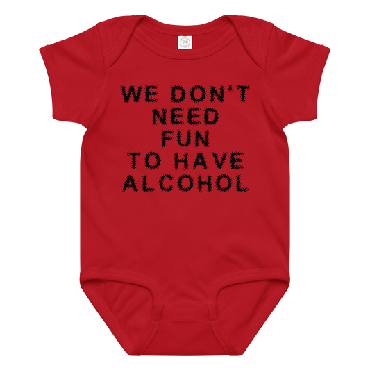 "We don’t need fun to have alcohol" printed on a red baby jersey bodysuit laying on a flat surface amongst other clothes