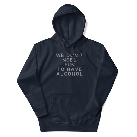 "We don’t need fun to have alcohol" printed on a navy blazer unisex hoodie laying on a flat surface with the hood up