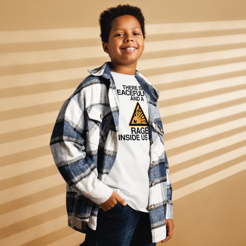 "There is a peacefulness and a rage inside us all" printed on a white youth classic tee worn by a male also wearing a jacket