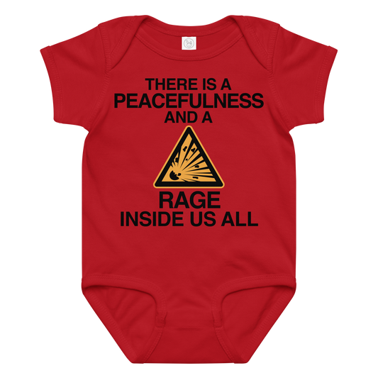 "There is a peacefulness and a rage inside us all" printed on a red baby jersey bodysuit laying on a flat surface amongst other clothes