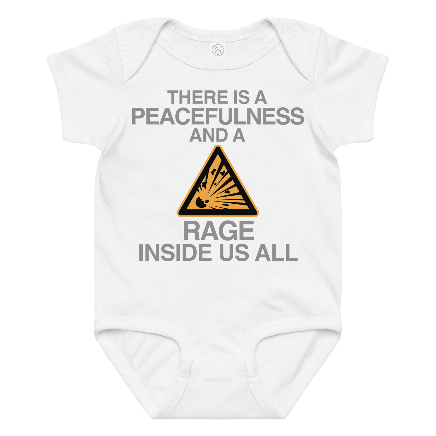 "There is a peacefulness and a rage inside us all" printed on a white baby jersey bodysuit laying on a flat surface amongst other clothes
