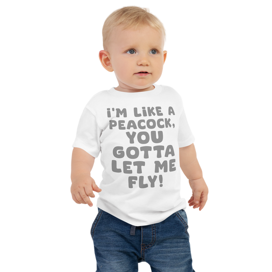 "I'm like a peacock, you gotta let me fly!" printed on a white baby jersey short sleeve tee worn by a male