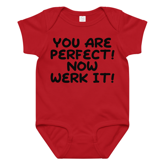 "You Are Perfect! Now Werk It!" printed on a red baby jersey bodysuit laying on a flat surface amongst other clothes
