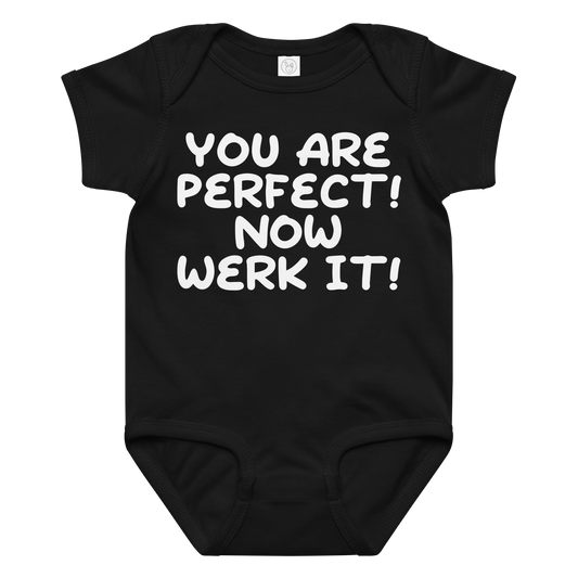 "You Are Perfect! Now Werk It!" printed on a black baby jersey bodysuit laying on a flat surface amongst other clothes