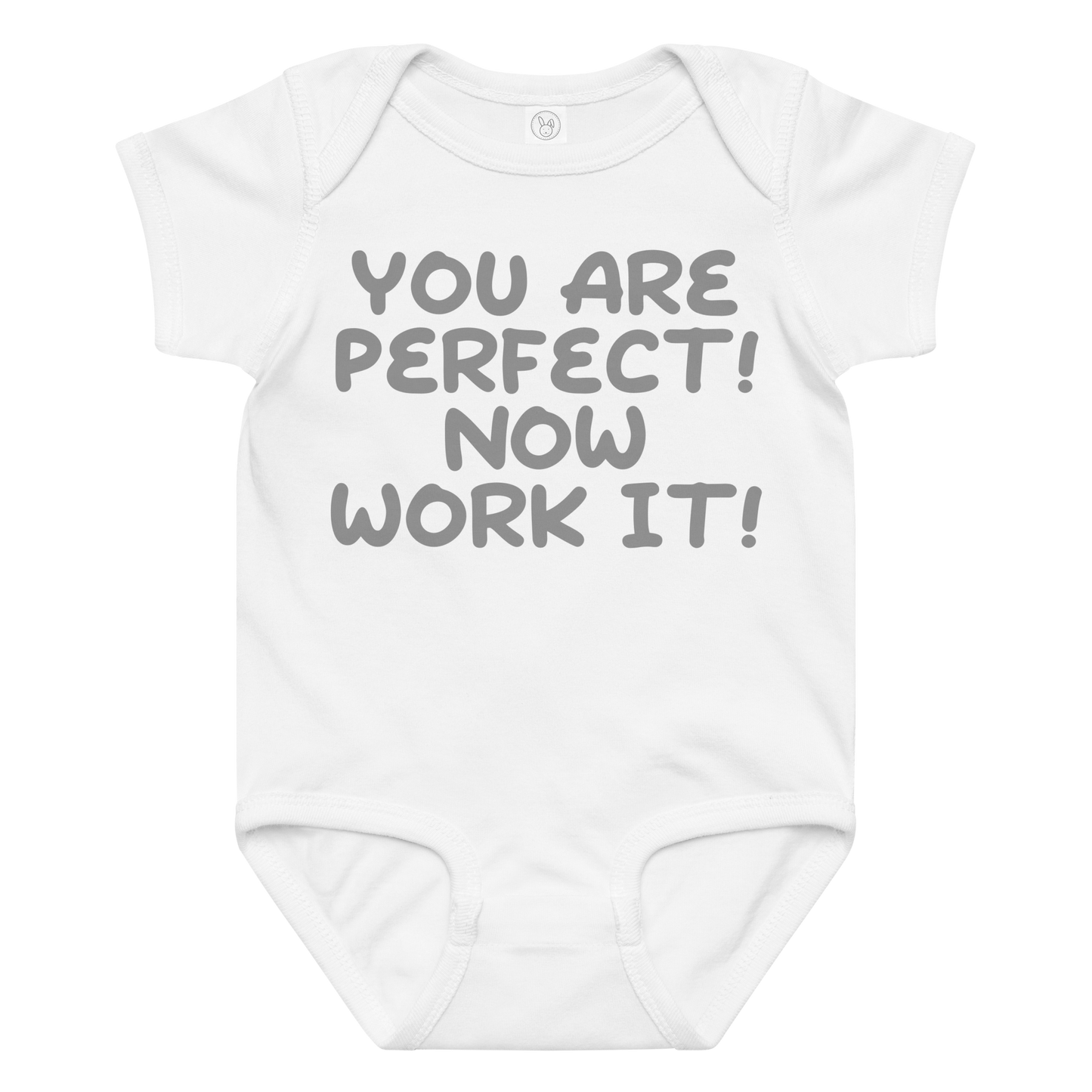 "You Are Perfect! Now Work It!" printed on a white baby jersey bodysuit laying on a flat surface amongst other clothes