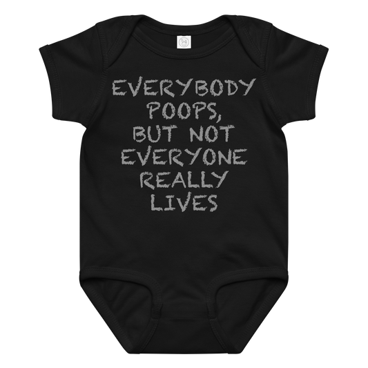 "Everybody poops, but not everyone really lives" printed on a black baby jersey bodysuit laying on a flat surface amongst other clothes