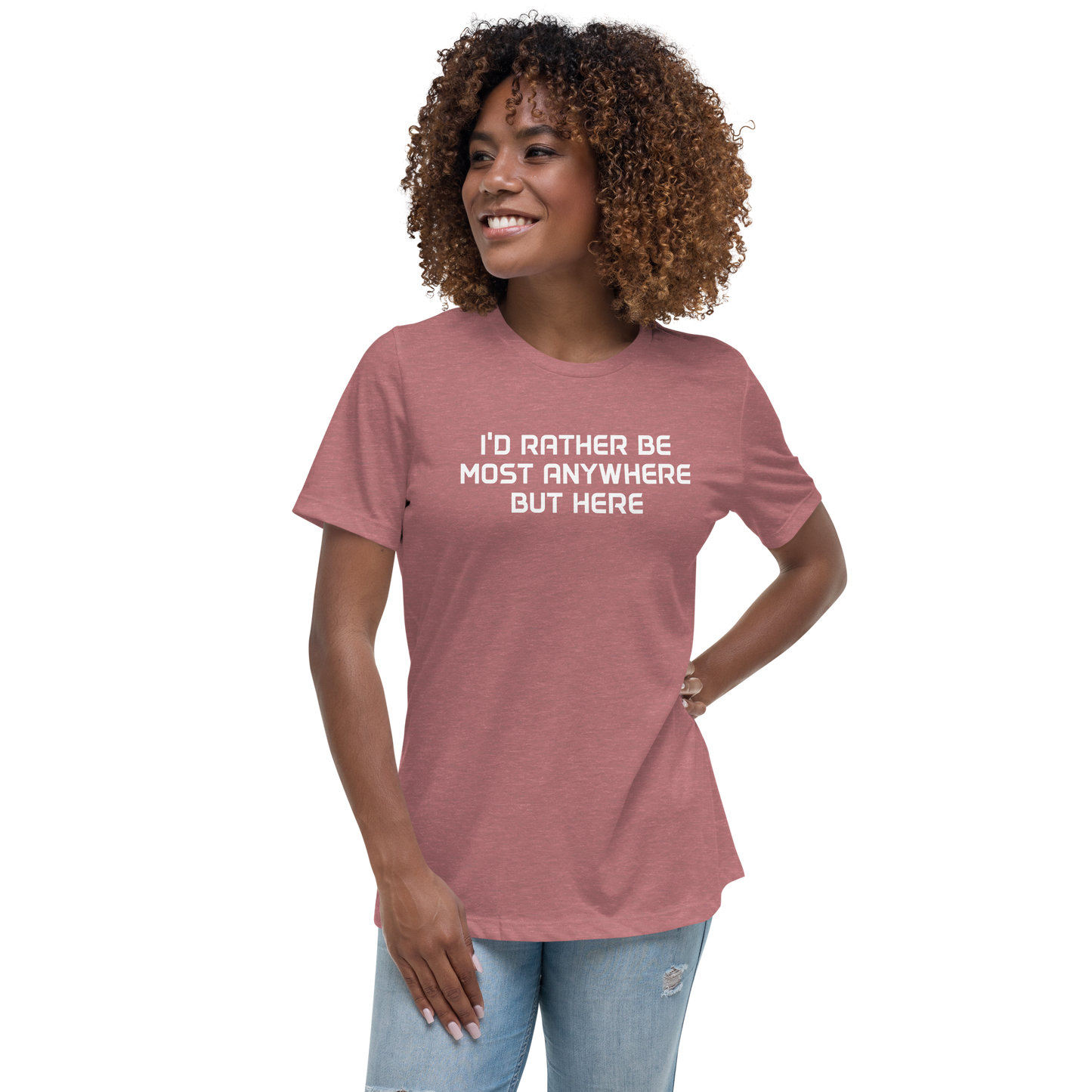 "I’d rather be most anywhere but here" printed on a heather mauve women's relaxed t-shirt worn by a female
