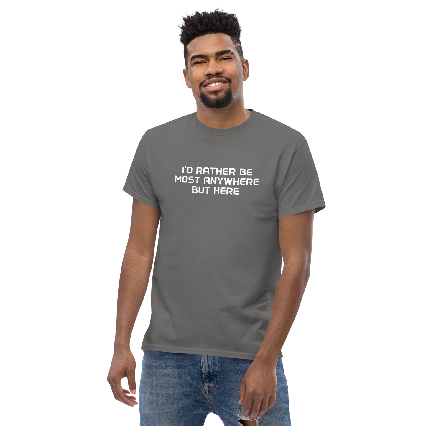 "I’d rather be most anywhere but here" printed on a charcoal unisex classic tee worn by a male