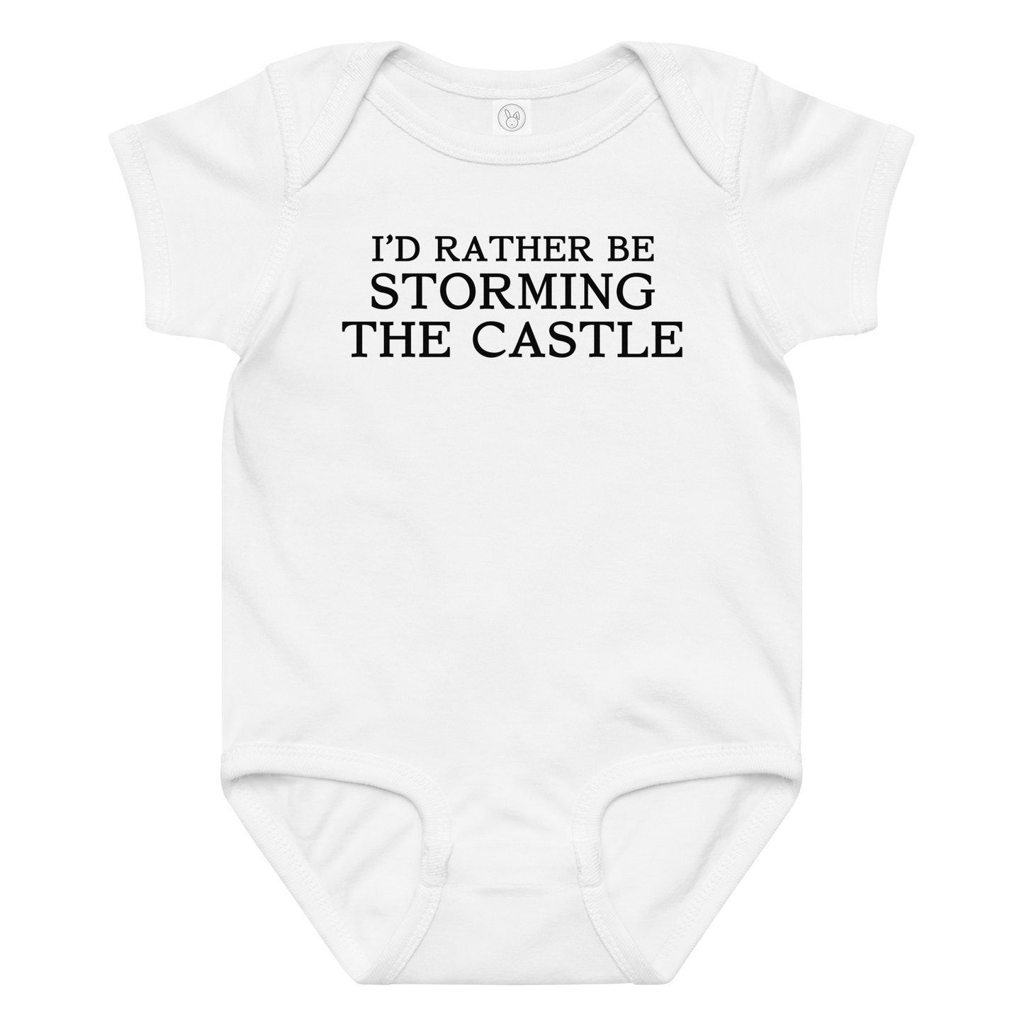 "I'd rather be storming the castle" printed on a white baby jersey bodysuit laying on a flat surface amongst other clothes