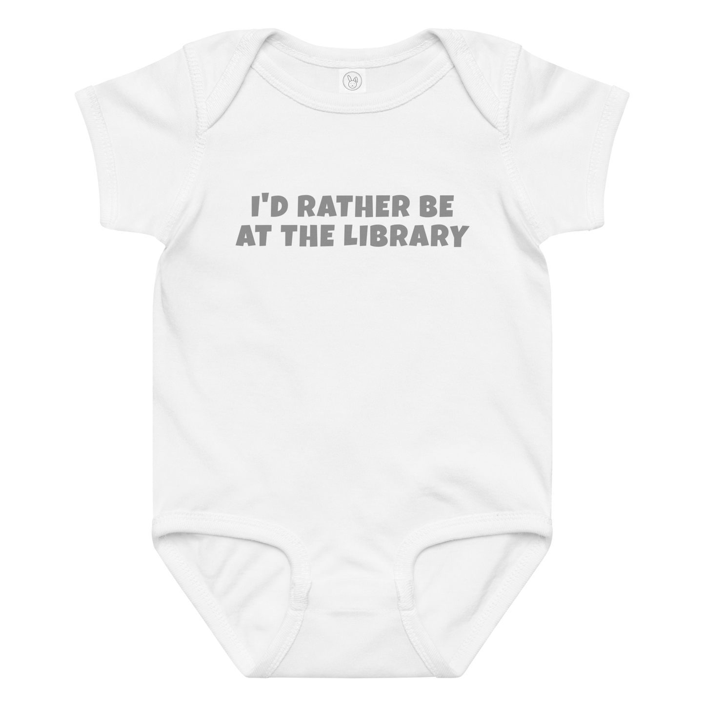 "I’d rather be at the library" printed on a white baby jersey bodysuit laying on a flat surface amongst other clothes