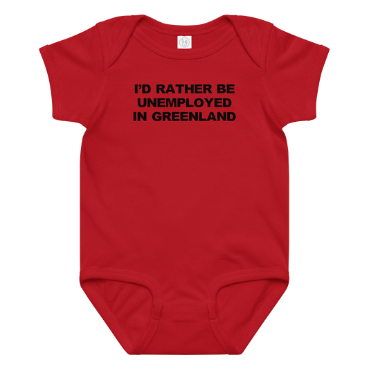 "I'd rather be unemployed in greenland" printed on a red baby jersey bodysuit laying on a flat surface amongst other clothes