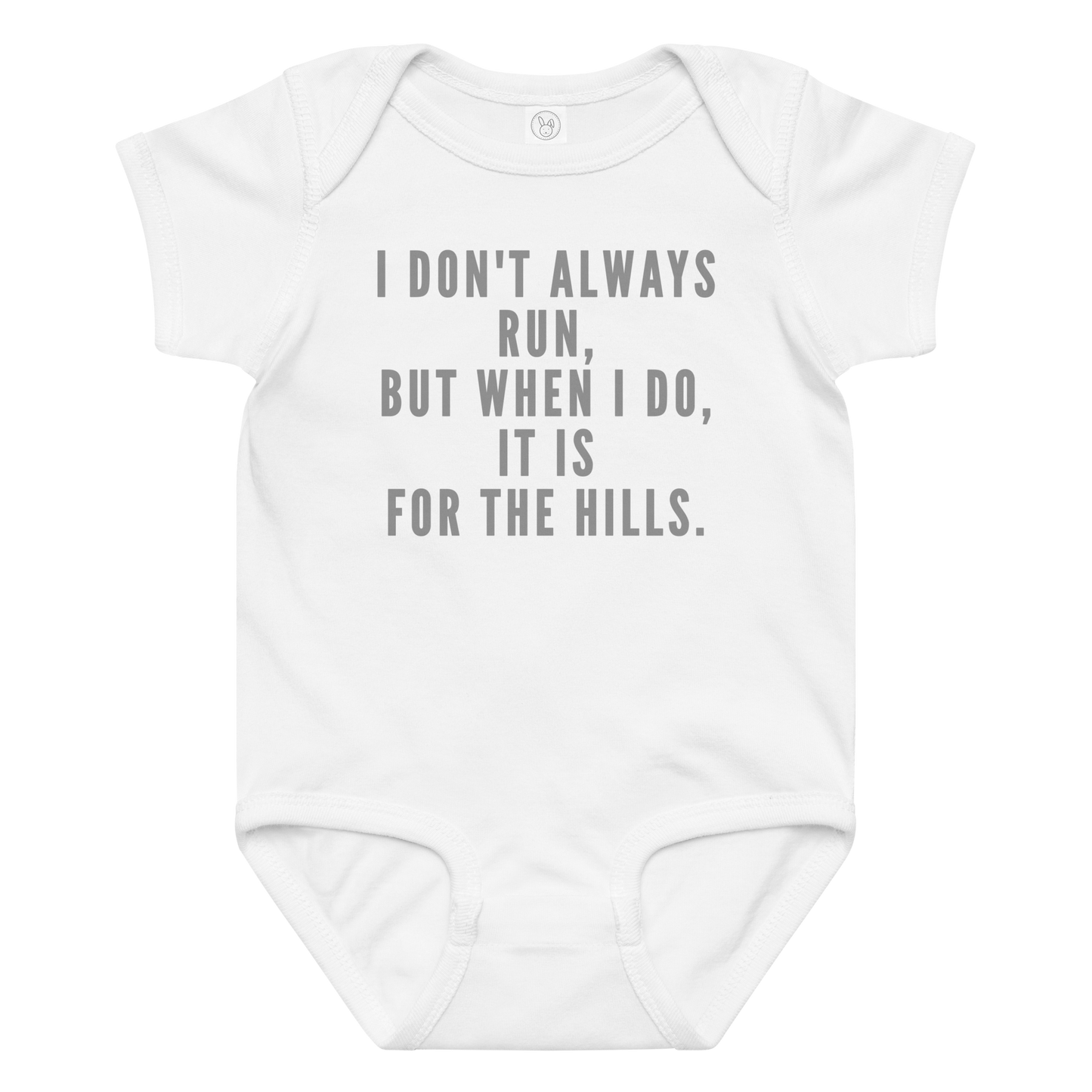 "I don't always run, but when I do, it is for the hills." printed on a white baby jersey bodysuit laying on a flat surface amongst other clothes