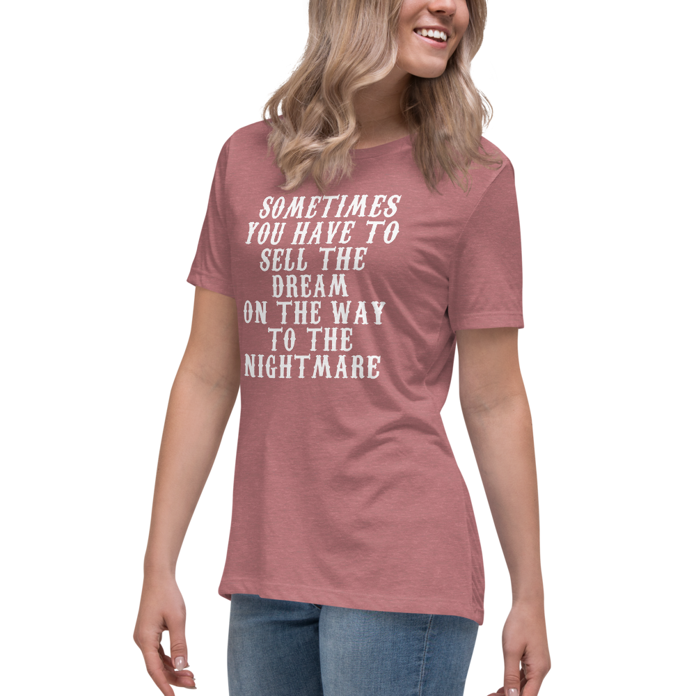 "Sometimes you have to sell the dream on the way to the nightmare" printed on a heather mauve women's relaxed t-shirt worn by a female