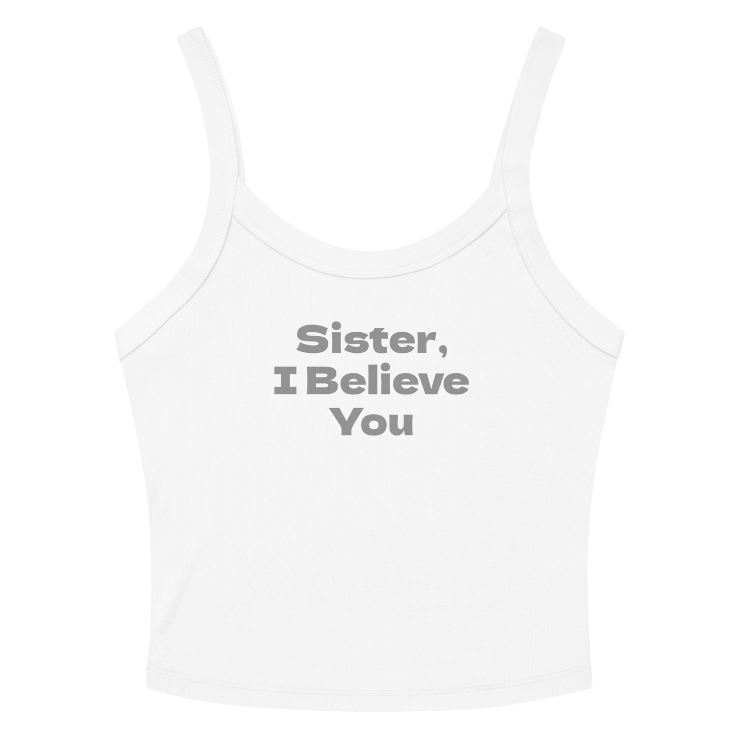 "Sister, I Believe You!" printed on a solid white blend women's micro-rib tanktop laying on a flat surface amongst sunglasses and shorts