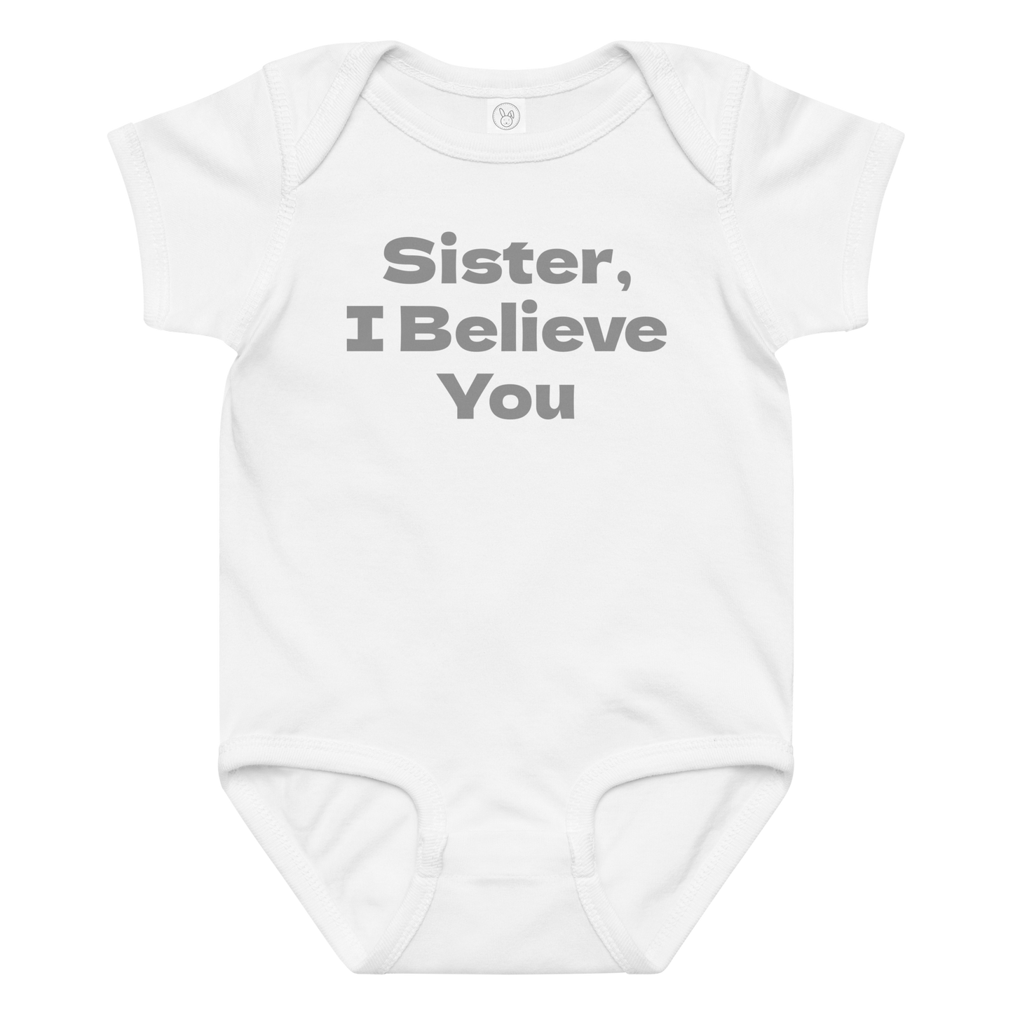 "Sister, I Believe You!" printed on a white baby jersey bodysuit laying on a flat surface amongst other clothes
