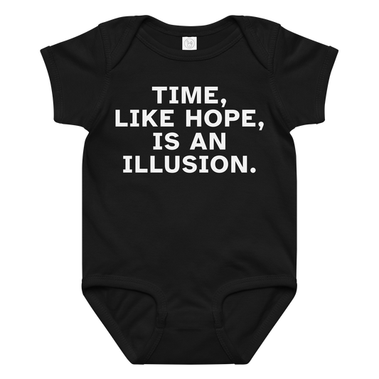"Time, like hope, is an illusion" printed on a black baby jersey bodysuit laying on a flat surface amongst other clothes