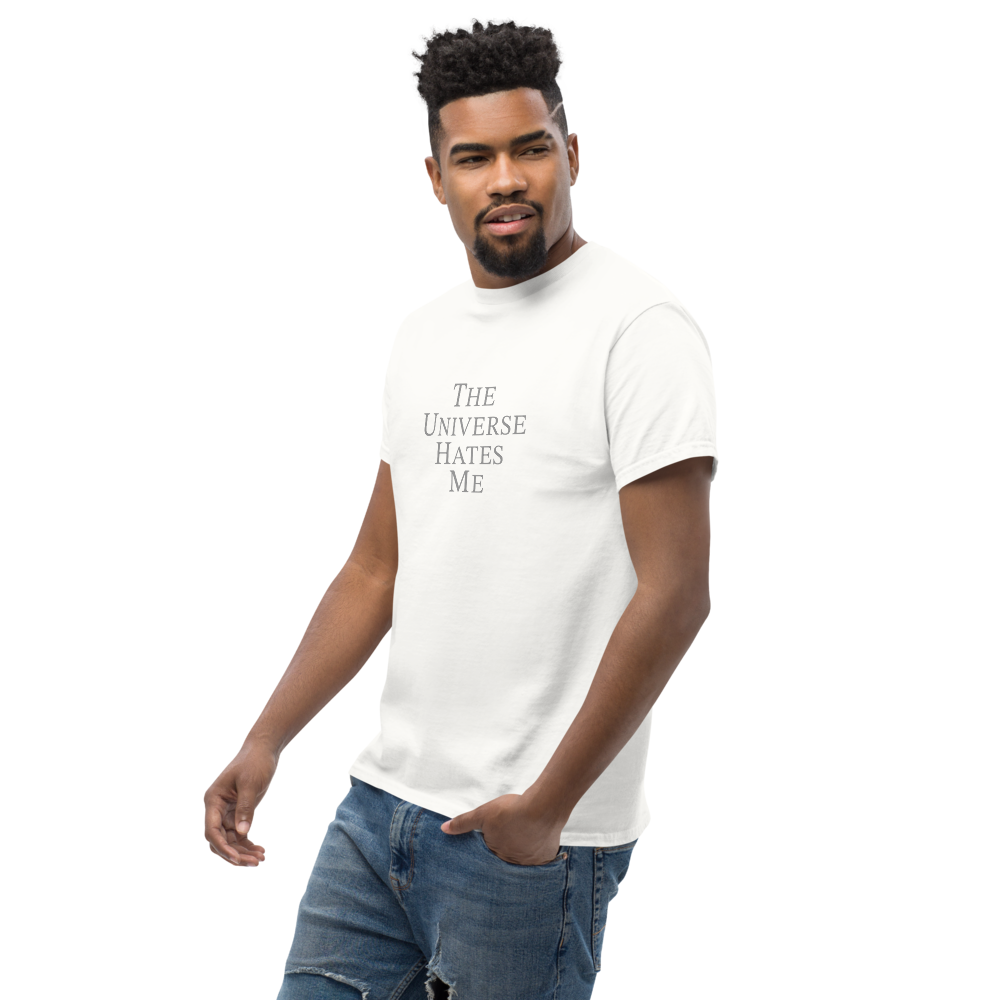 "The Universe Hates Me" printed on a white unisex classic tee worn by a male