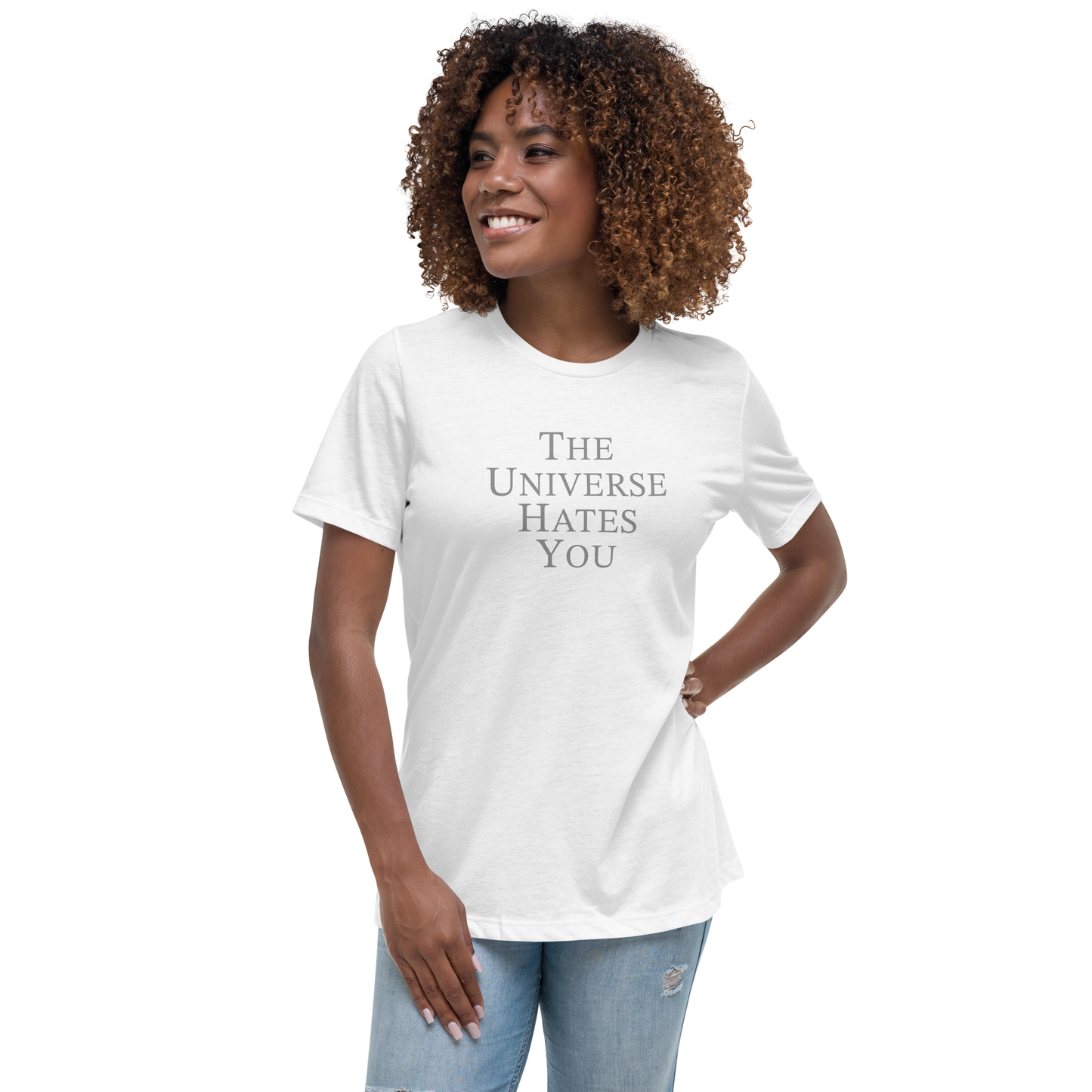"The Universe Hates You" printed on a white women's relaxed t-shirt worn by a female