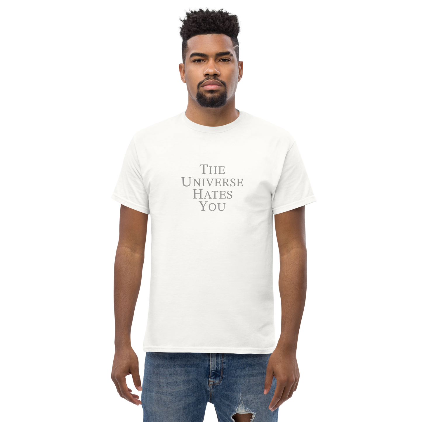"The Universe Hates You" printed on a white unisex classic tee worn by a male