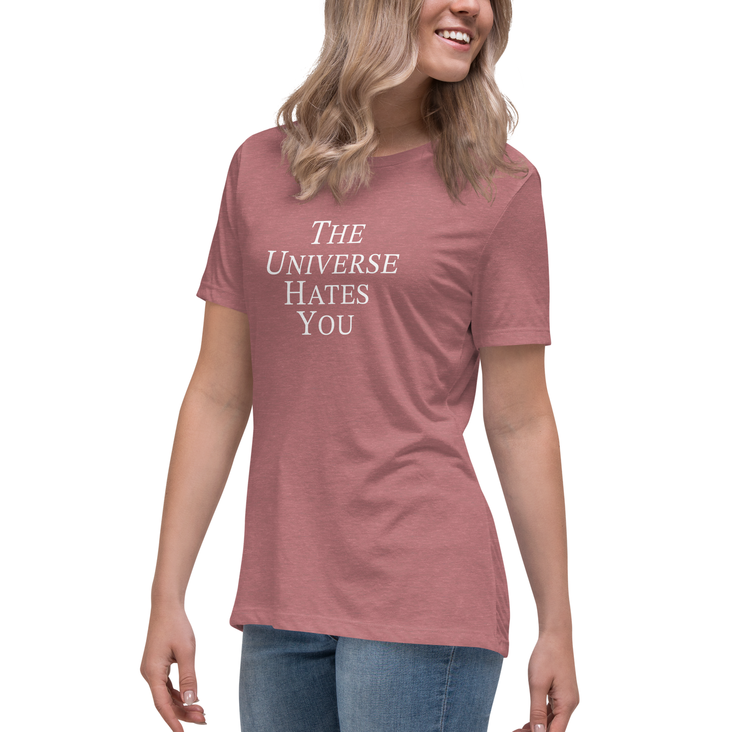 "The Universe Hates You" printed on a heather mauve women's relaxed t-shirt worn by a female
