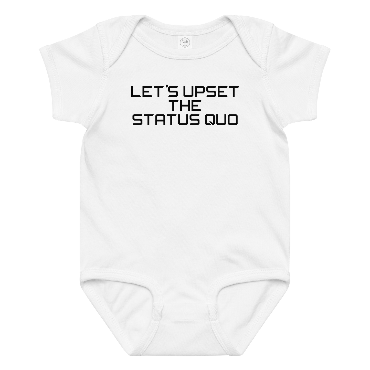 "Let's upset the status quo!" printed on a white baby jersey bodysuit laying on a flat surface amongst other clothes