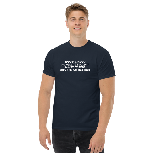 "Don't worry, my village didn’t want their idiot back either." printed on a navy unisex classic tee worn by a male