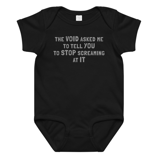 "The Void asked me to tell you to stop screaming at it" printed on a black baby jersey bodysuit laying on a flat surface amongst other clothes