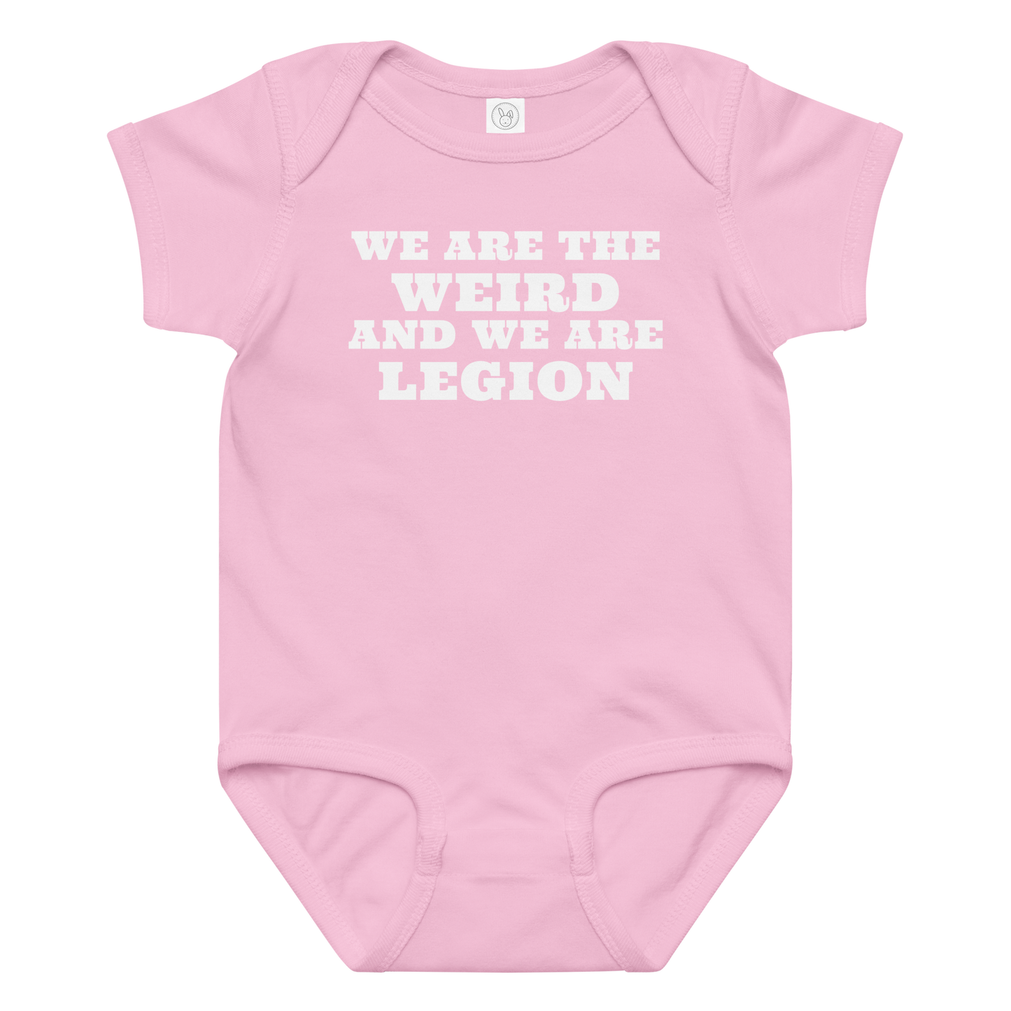 "We are the weird and we are legion" printed on a pink baby jersey bodysuit laying on a flat surface amongst other clothes