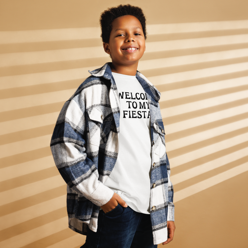 "Welcome to my fiesta!" printed on a white youth classic tee worn by a male also wearing a jacket