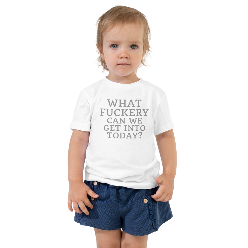 "What fuckery can we get into today?" printed on a white toddler short sleeve tee worn by a female
