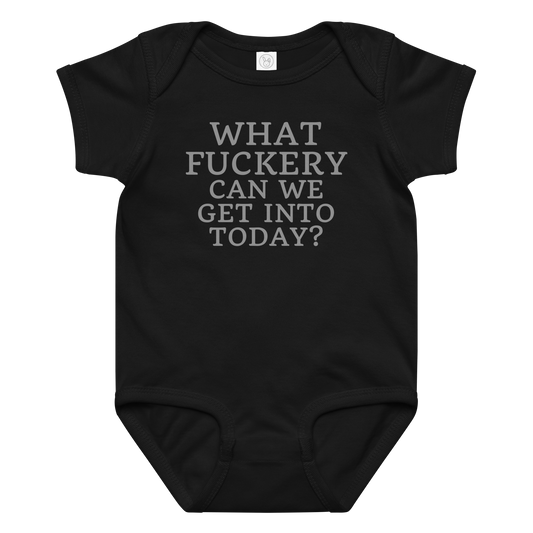 "What fuckery can we get into today?" printed on a black baby jersey bodysuit laying on a flat surface amongst other clothes