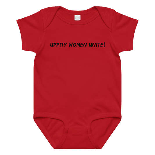 "Uppity Women Unite" printed on a red baby jersey bodysuit laying on a flat surface amongst other clothes