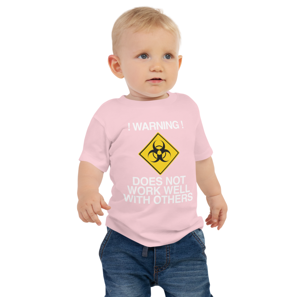 "!Warning! Does Not Work Well With Others" printed on a pink baby jersey short sleeve tee worn by a male