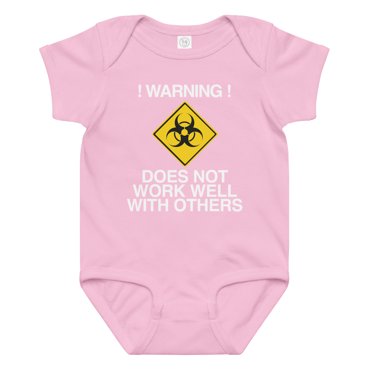 "!Warning! Does Not Work Well With Others" printed on a pink baby jersey bodysuit laying on a flat surface amongst other clothes