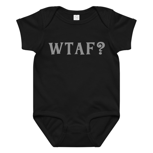 "WTAF?" printed on a black baby jersey bodysuit laying on a flat surface amongst other clothes