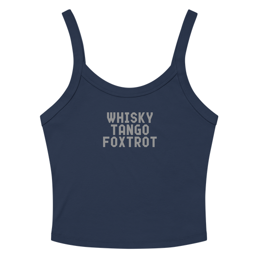 "Whisky Tango Foxtrot (What the f#ck)" printed on a solid navy blend women's micro-rib tanktop laying on a flat surface amongst sunglasses and shorts