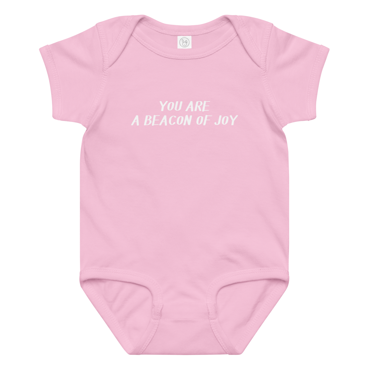 "You are a beacon of joy" printed on a pink baby jersey bodysuit laying on a flat surface amongst other clothes