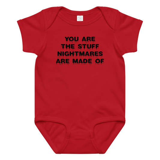 "You are the stuff nightmares are made of" printed on a red baby jersey bodysuit laying on a flat surface amongst other clothes