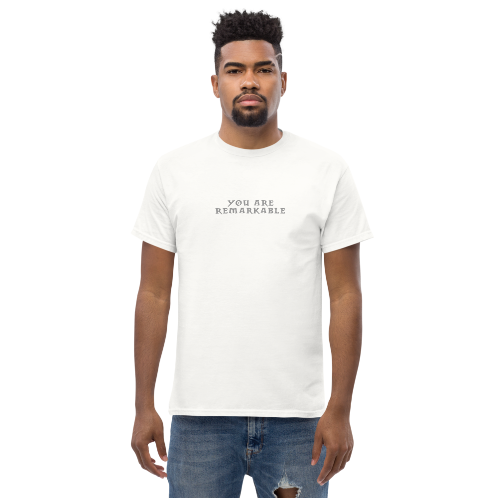 "You are remarkable" printed on a white unisex classic tee worn by a male