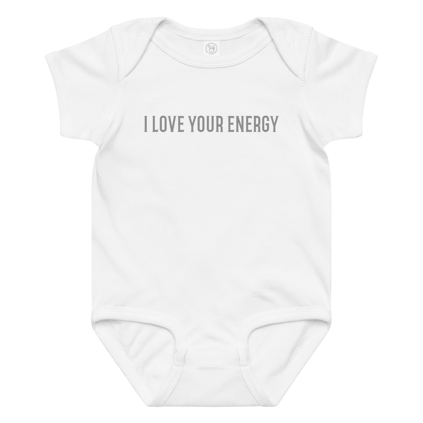 "I love your energy" printed on a white baby jersey bodysuit laying on a flat surface amongst other clothes