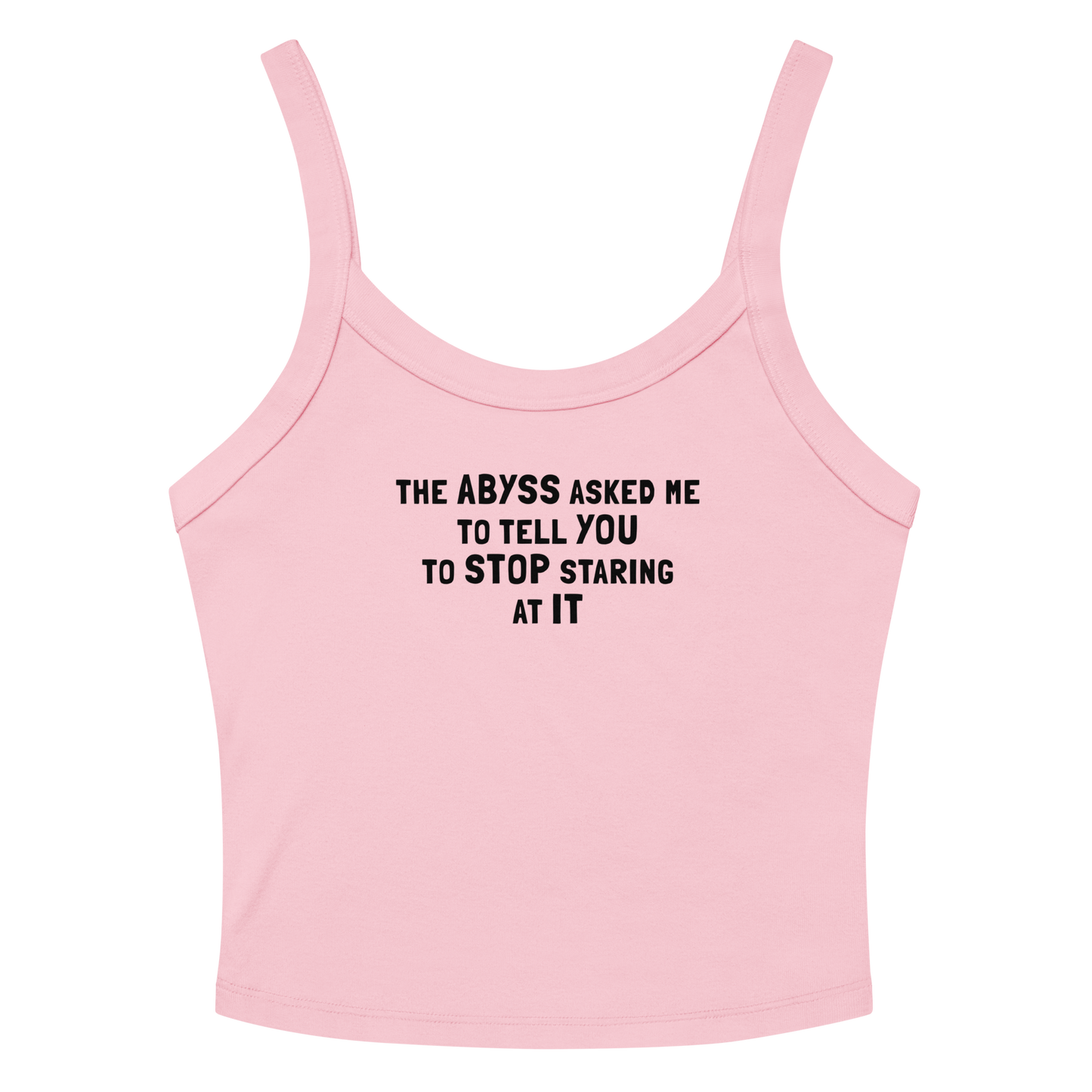 "The Abyss asked me to tell you to stop staring at it" printed on a solid pink blend women's micro-rib tanktop laying on a flat surface amongst sunglasses and shorts