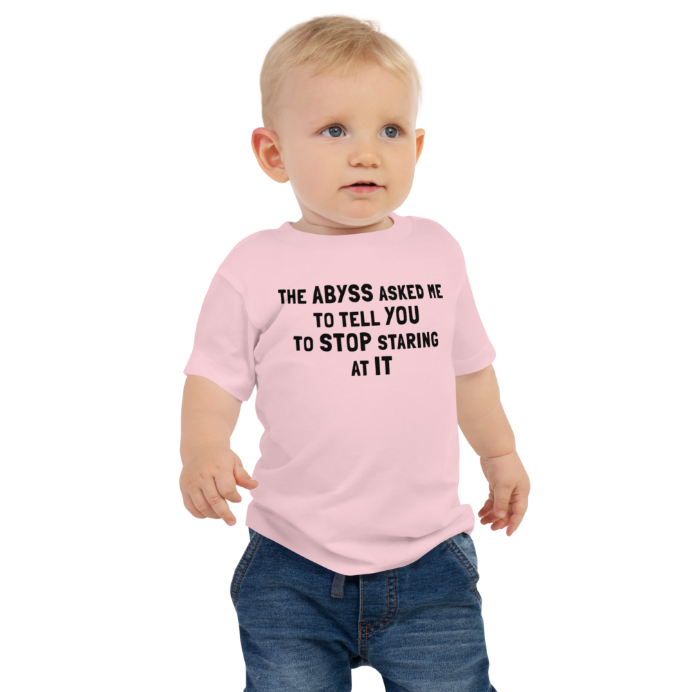 "The Abyss asked me to tell you to stop staring at it" printed on a pink baby jersey short sleeve tee worn by a male